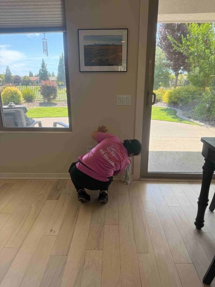 Cleaning a hardwood floor by the patio door