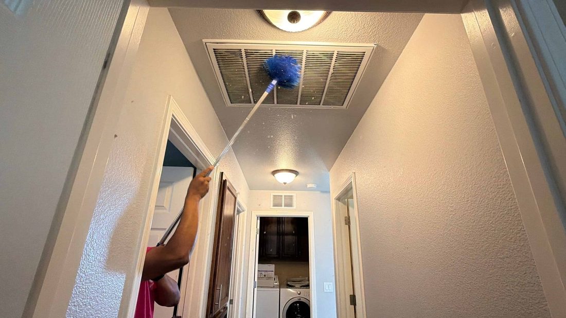 Letty's team dusting a ceiling vent